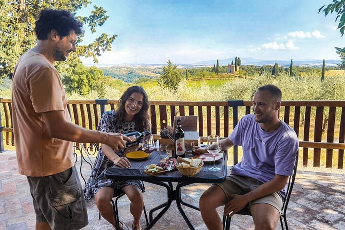 two men and a woman sitting at a table with food