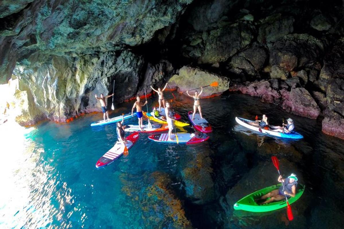 a group of people in boats in a cave