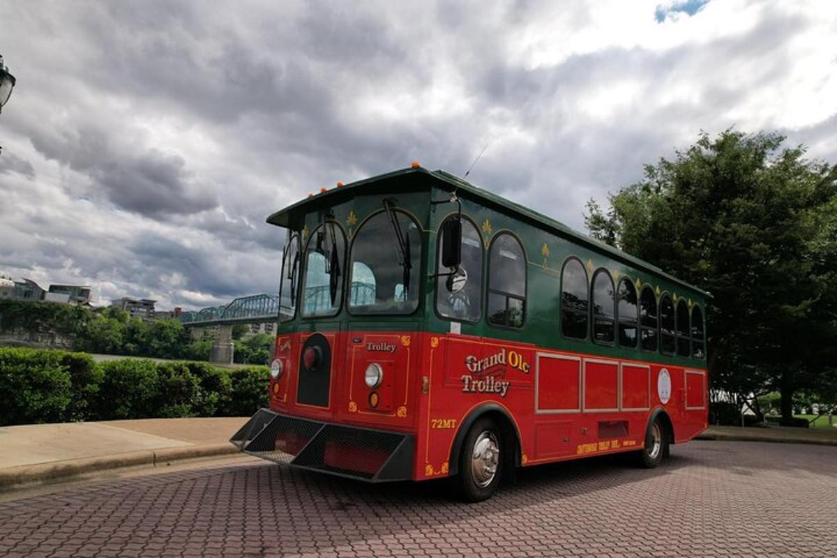 a red and green bus driving down a street