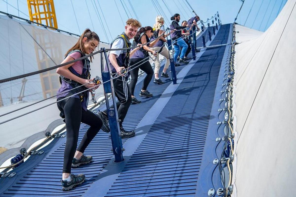 a group of people walking across a rope bridge