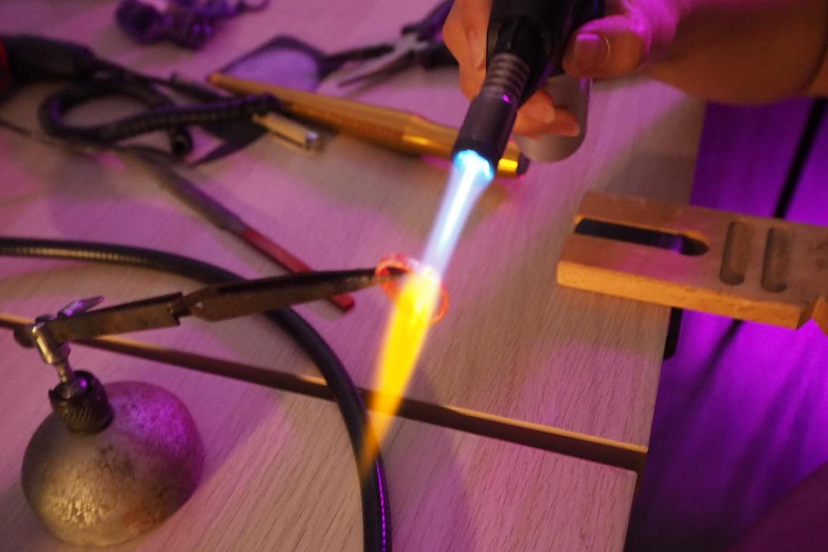 a person is lighting a lighter on a table