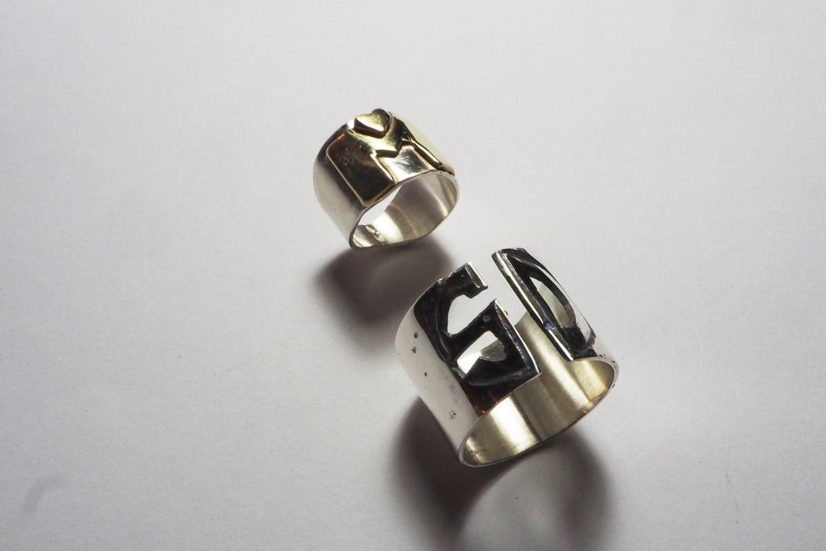 a pair of silver and gold earrings with the number four