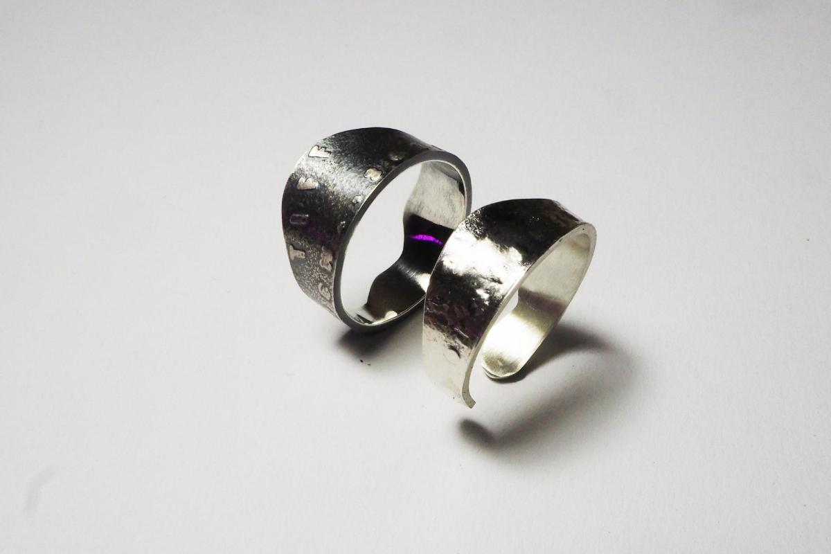 a pair of sterling silver rings with a purple gem