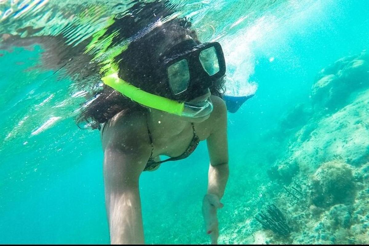 a woman in the water with a diving mask on