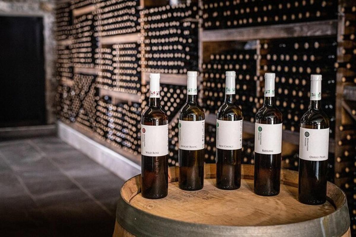 a group of wine bottles sitting on a barrel