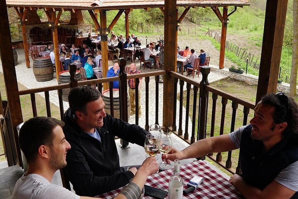 a group of men sitting at a table with wine glasses