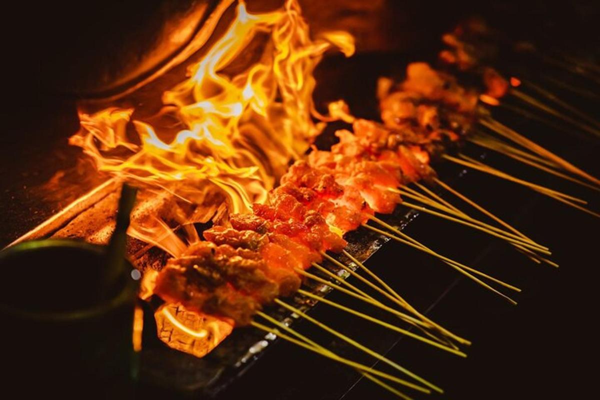 a bunch of food on a grill with flames