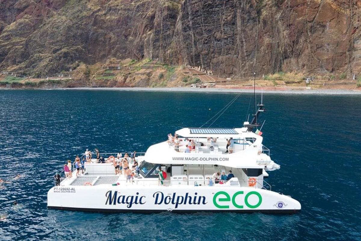 a large white boat in the water with people on it