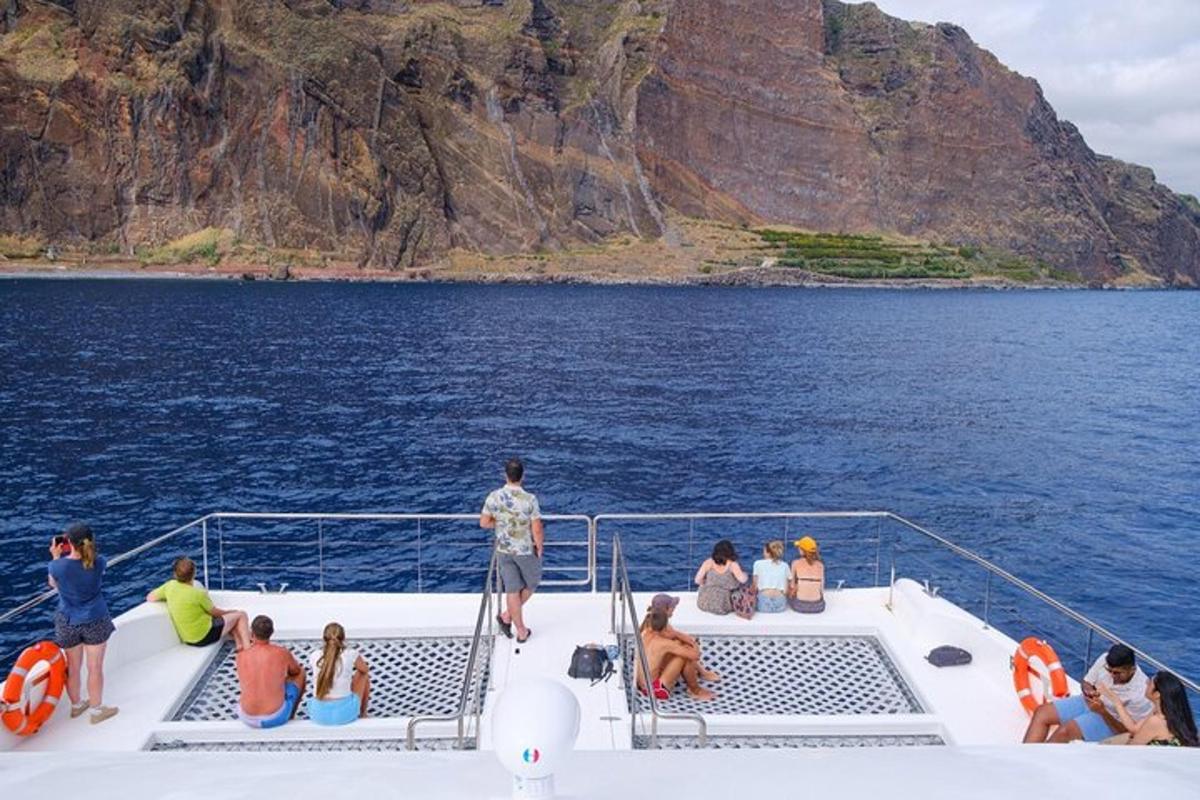 a group of people sitting on the deck of a boat