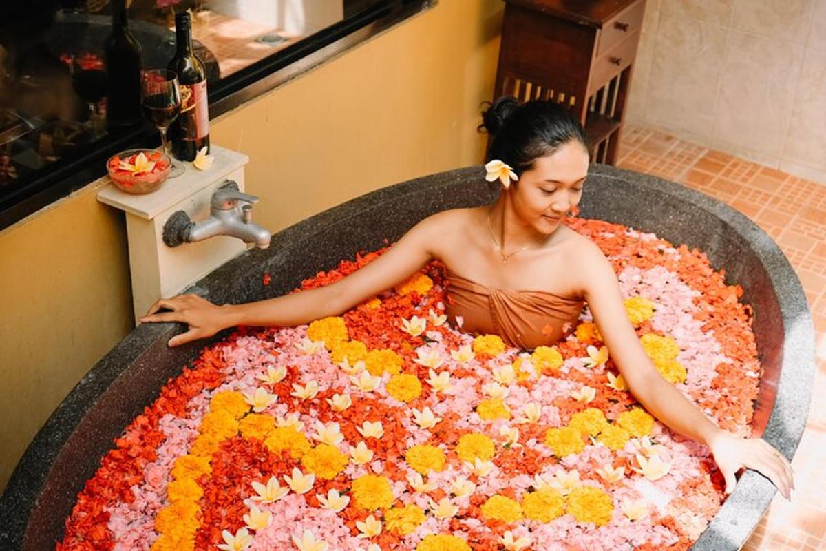 a woman sitting in a bath tub covered in flowers