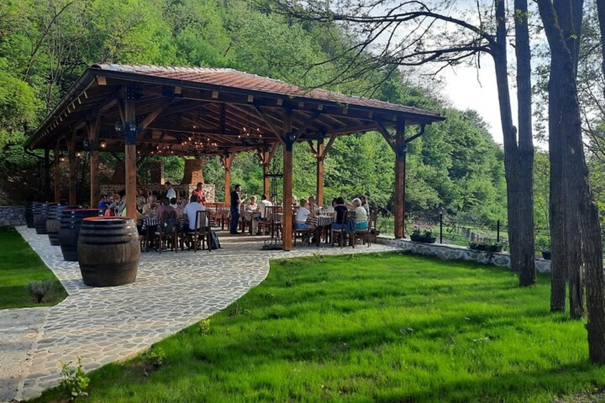 a group of people sitting under a pavilion in a park