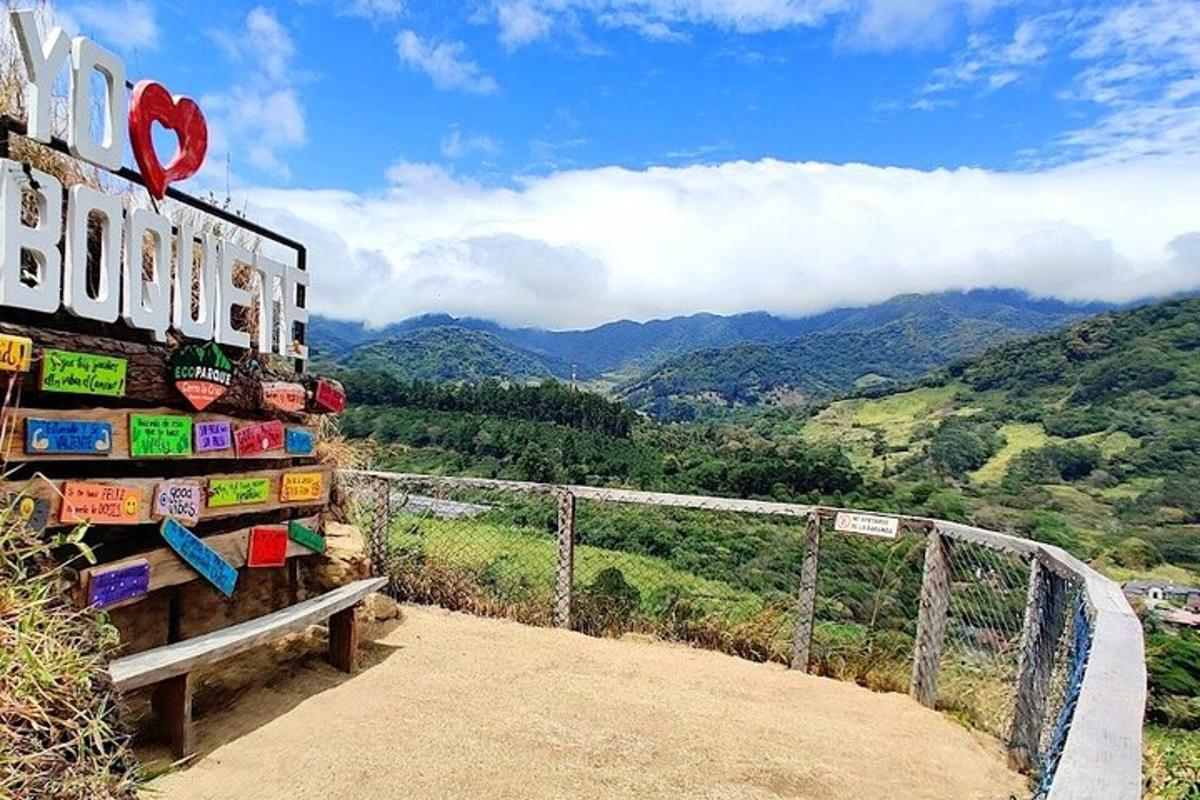 a sign for a bus stop with mountains in the background