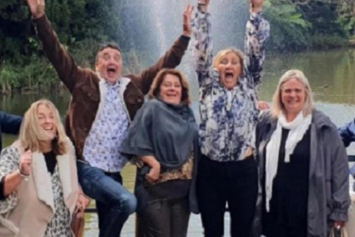 a group of people with their hands in the air