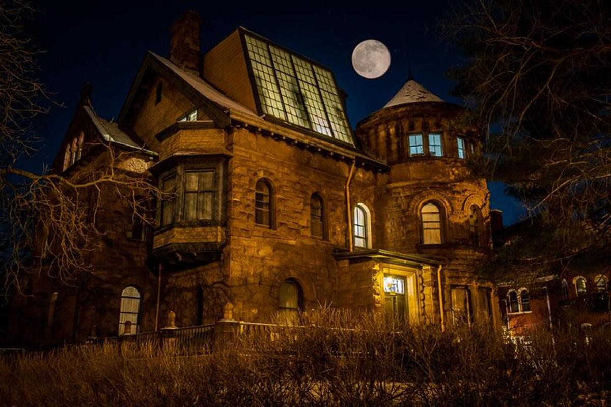 an old building with a moon in the sky