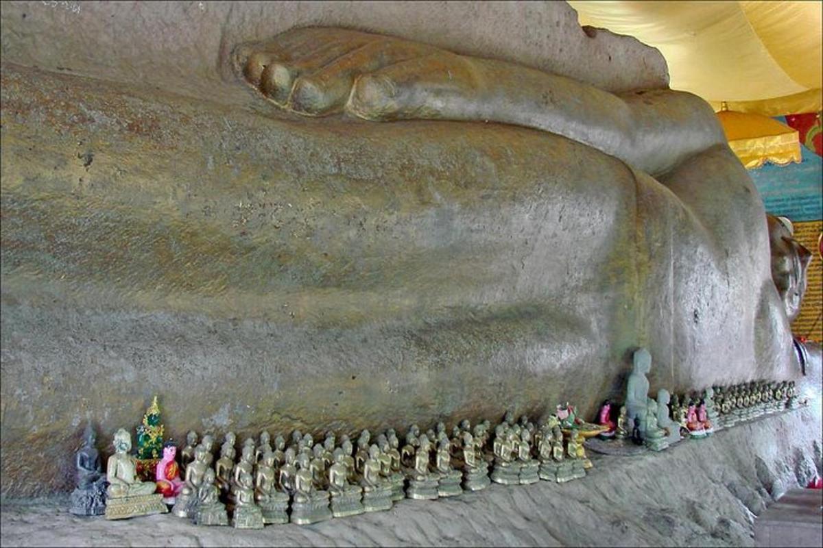 a group of figurines standing next to a statue