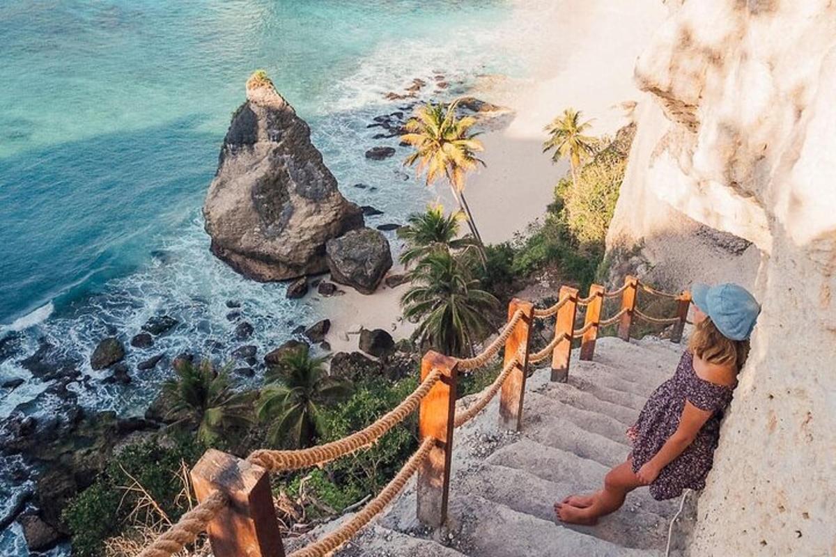 a woman walking down stairs near the ocean