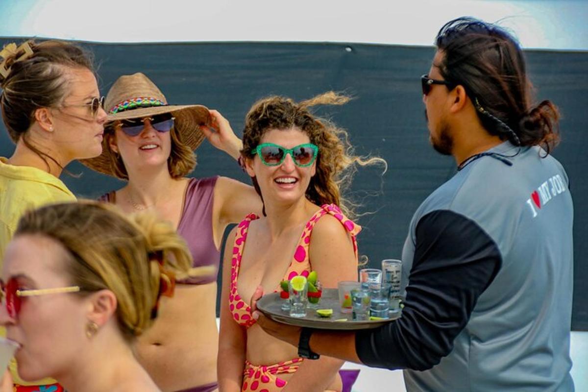 a woman in a bikini holding a tray of drinks