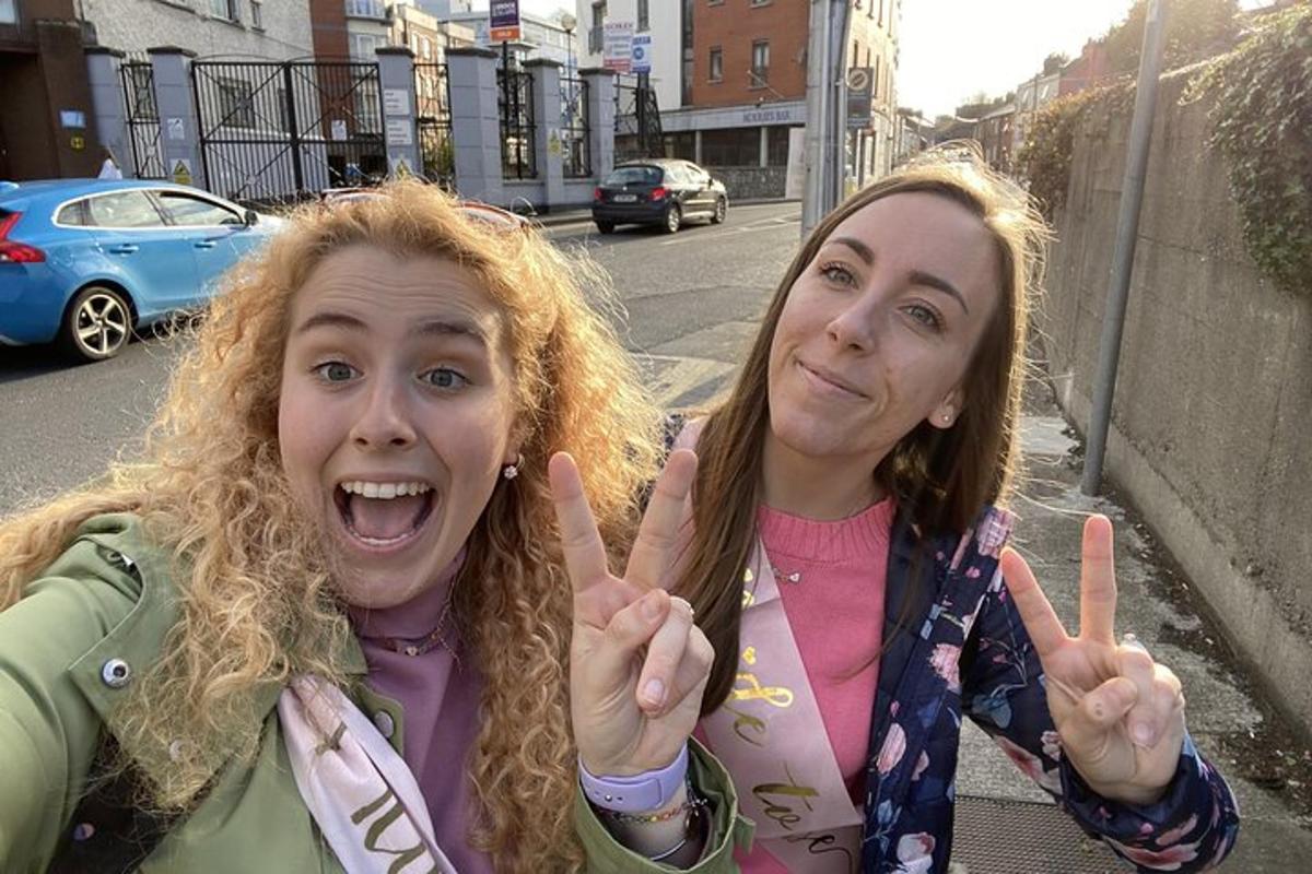 two girls giving the peace sign with their hands