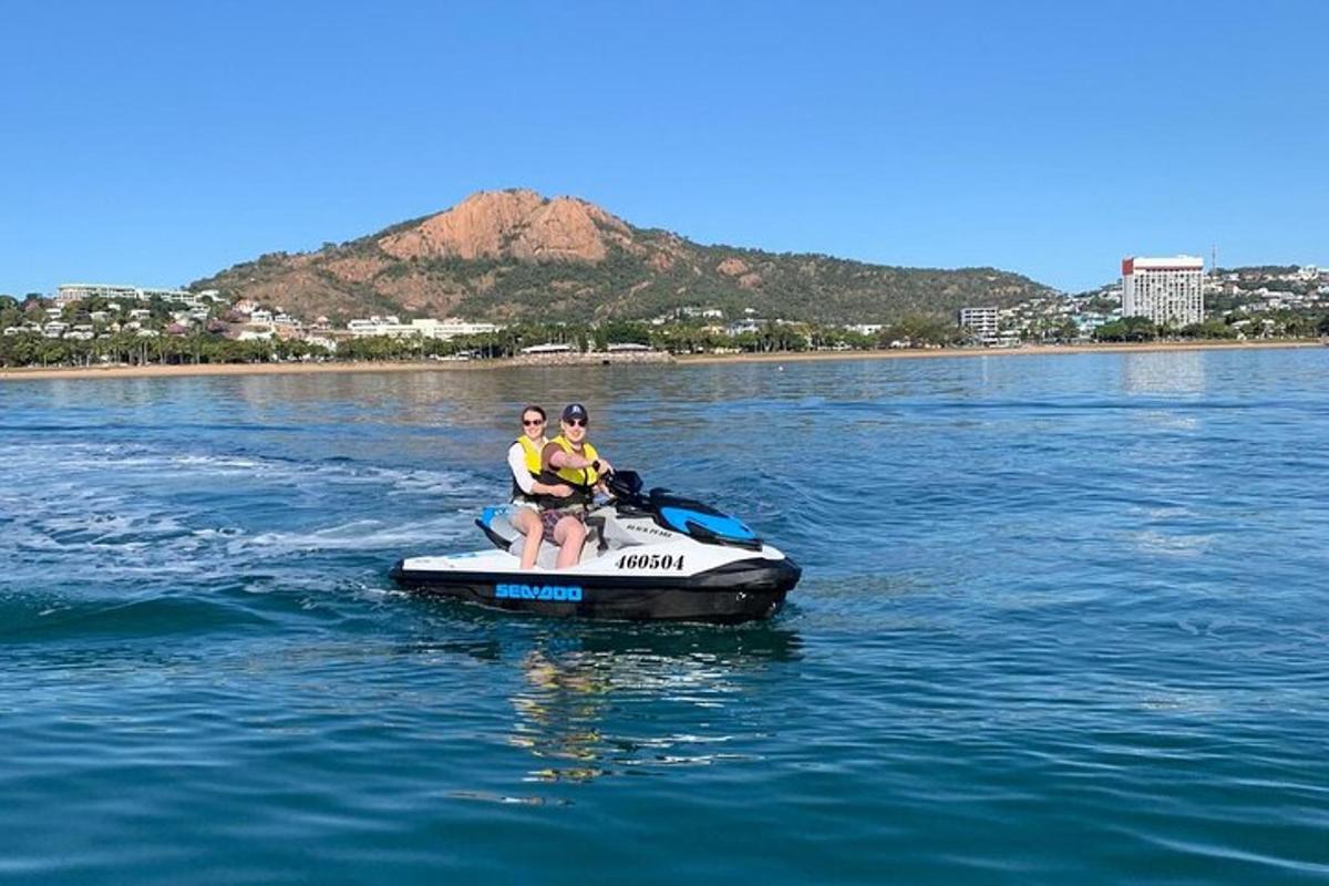 three people on a jet ski in the water