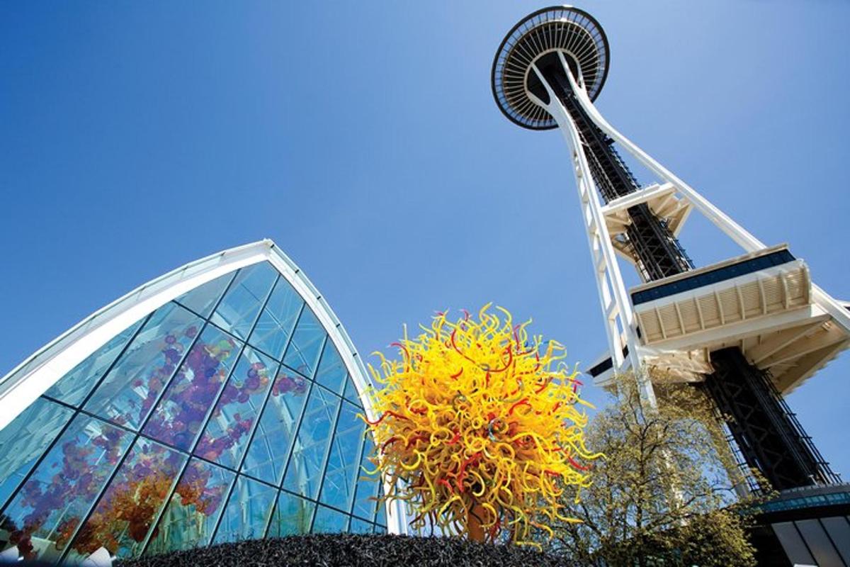 a roller coaster in front of a glass building