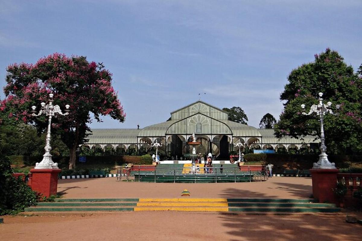 a large building with a fountain in a park