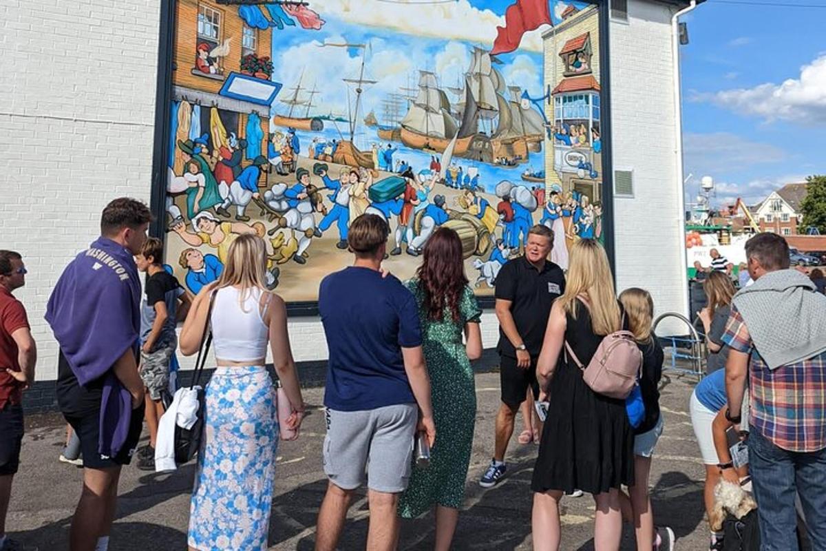 a group of people standing in front of a mural