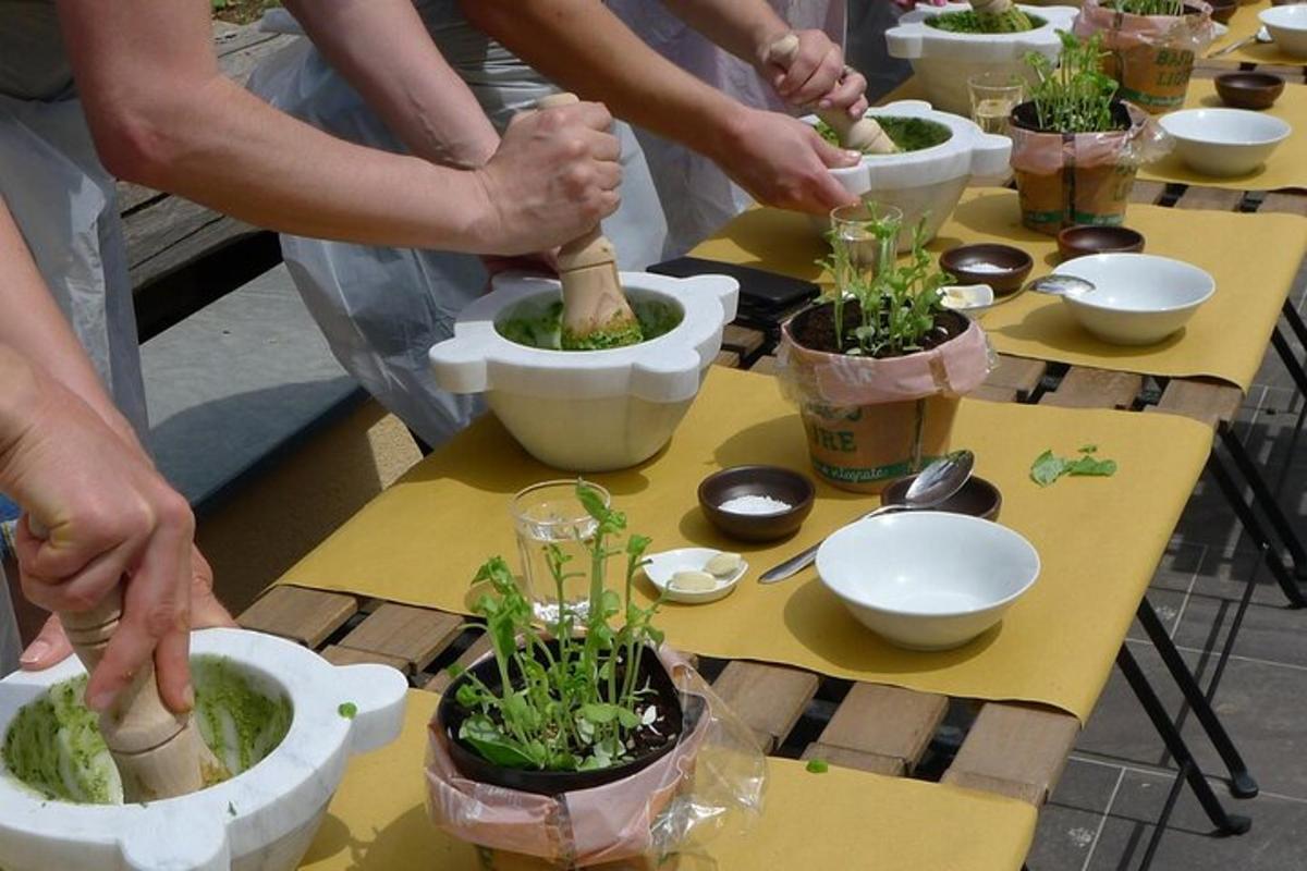 a group of people planting plants in pots on a table