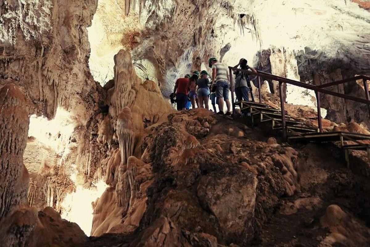 a group of people standing on a staircase in a cave