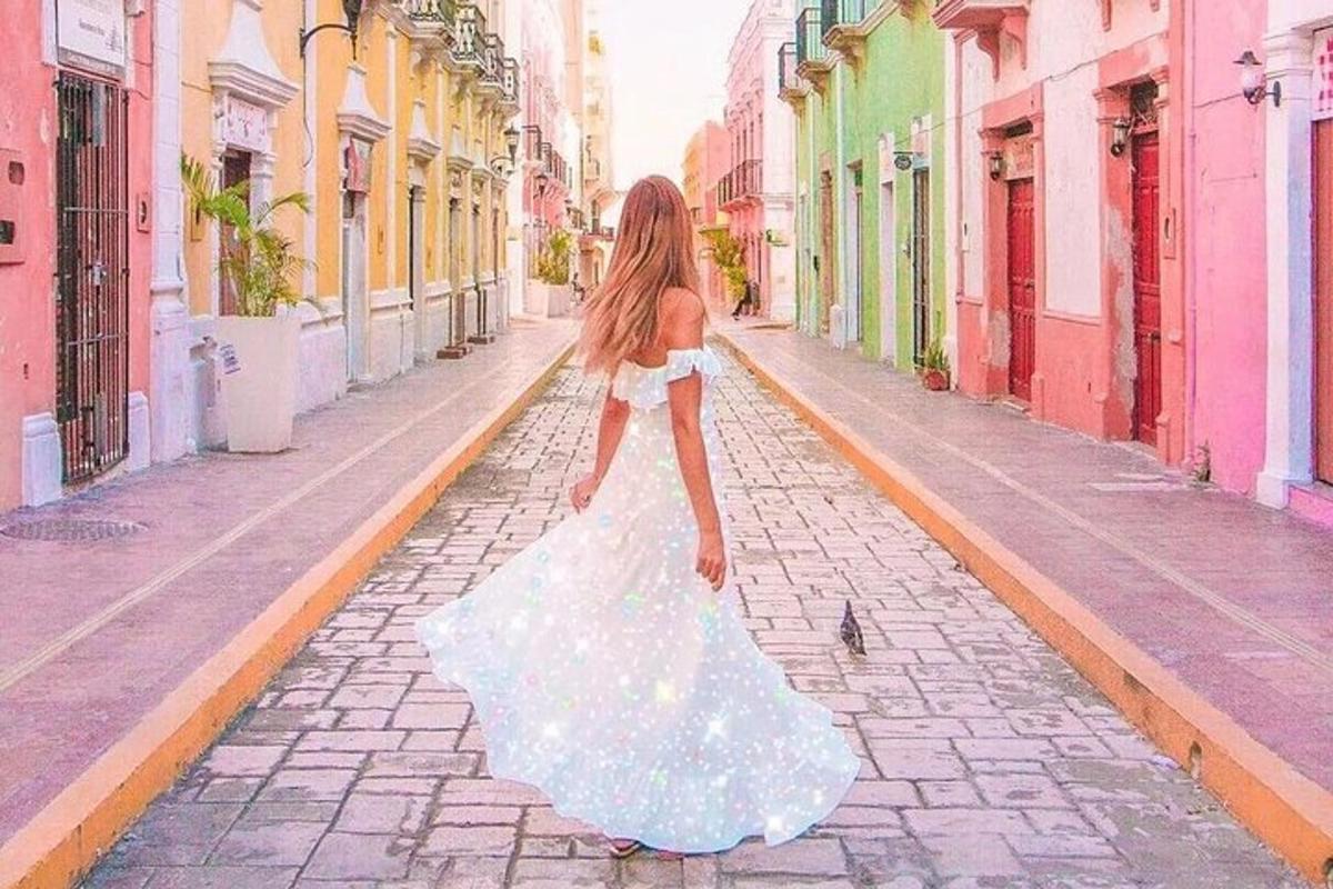 a woman in a dress walking down a street