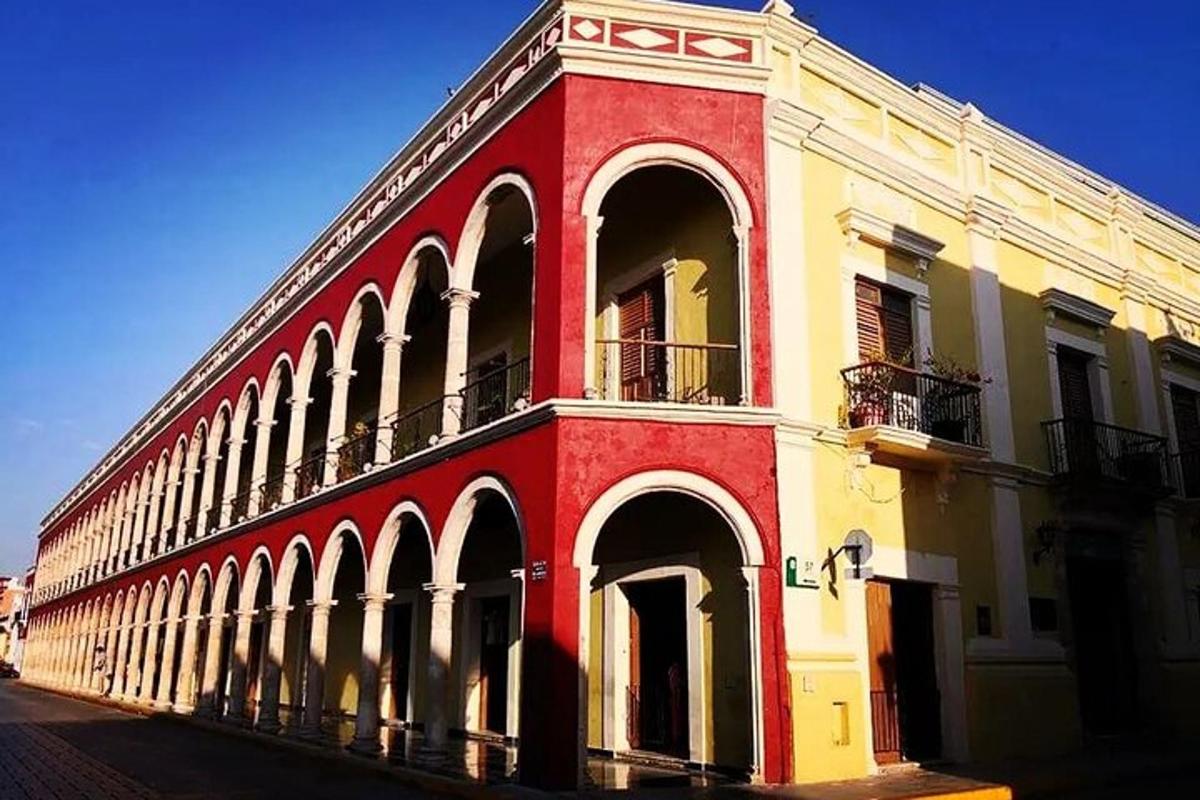 a red and white building with arches on a street
