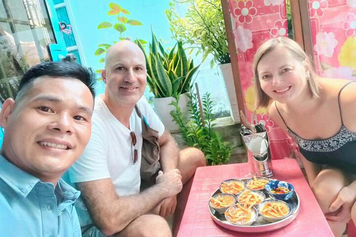 a man and woman sitting at a table with a plate of food