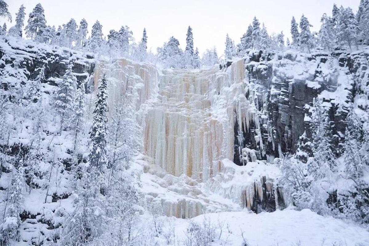 a view of a waterfall in the snow