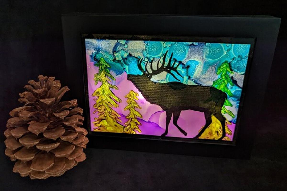 a painting of a deer and a pine cone