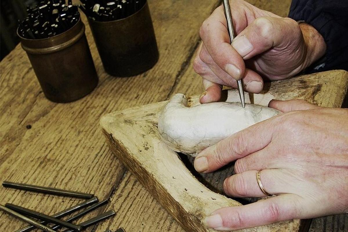 a person cutting up a mushroom on a cutting board