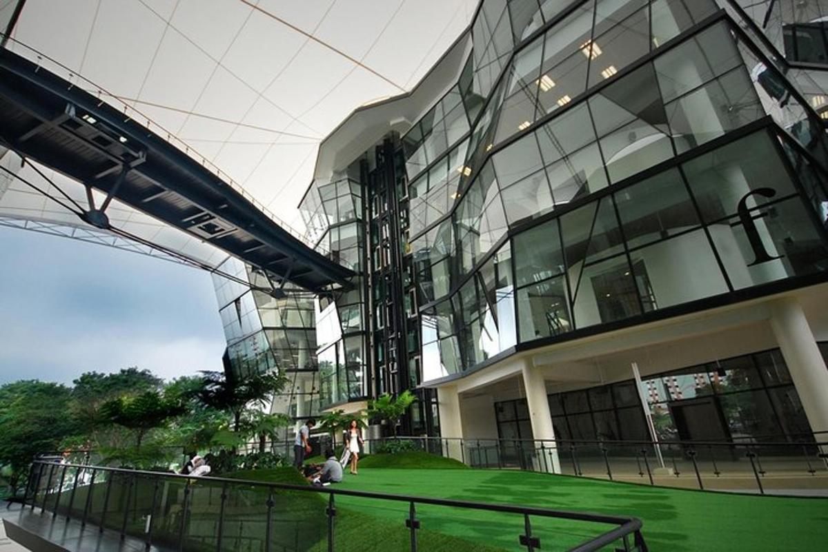 a large building with a green lawn in front of it