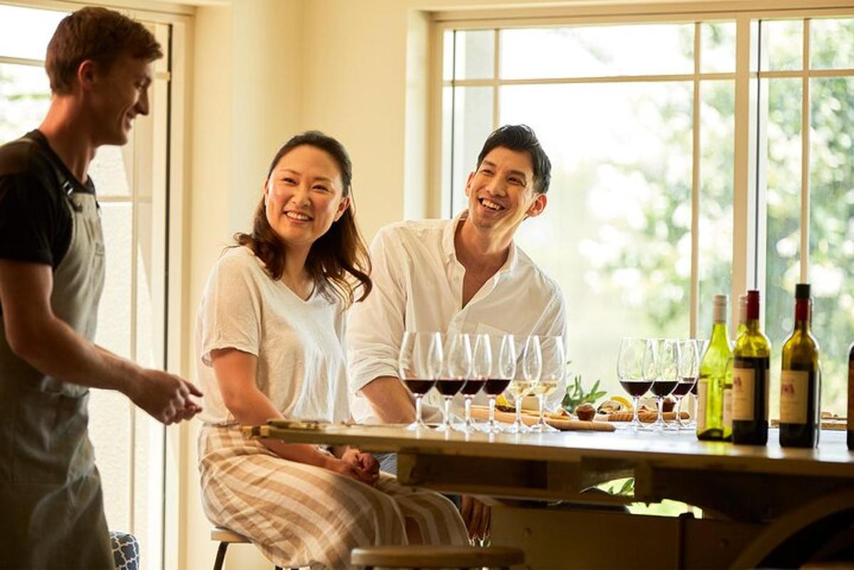 a group of people standing around a table with wine glasses