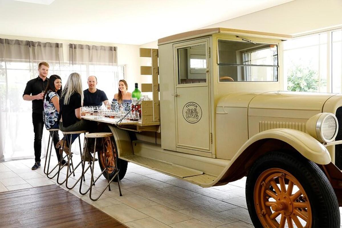 a group of people standing around an old truck