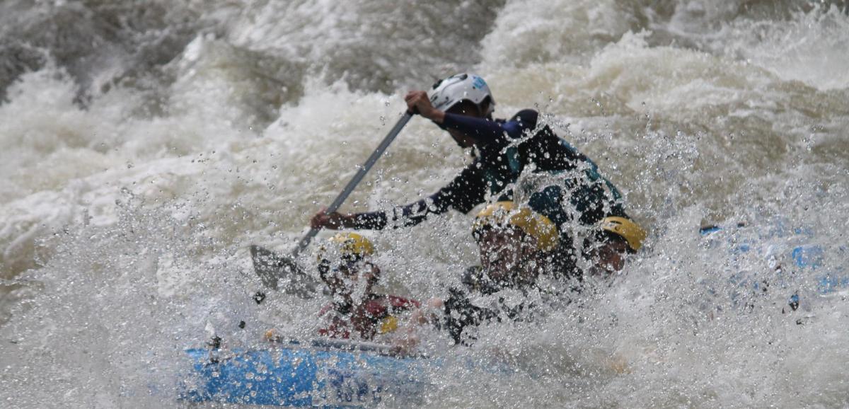 a man is on a raft in a river