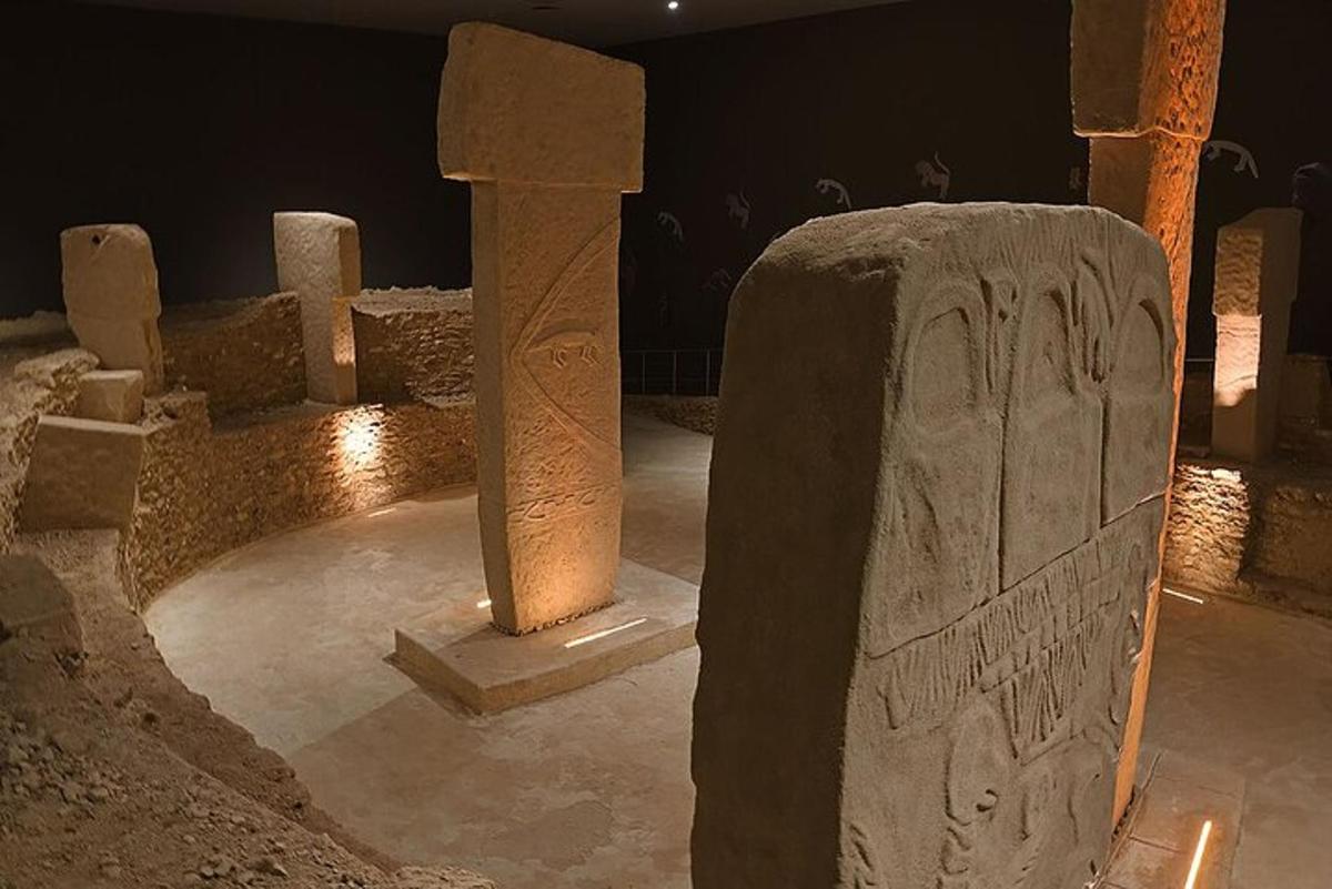 a group of stone pillars in a room at night