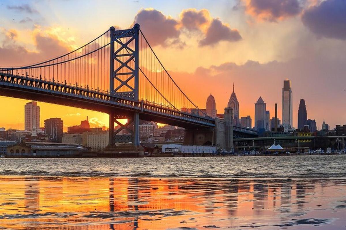 a bridge over the water with a city in the background