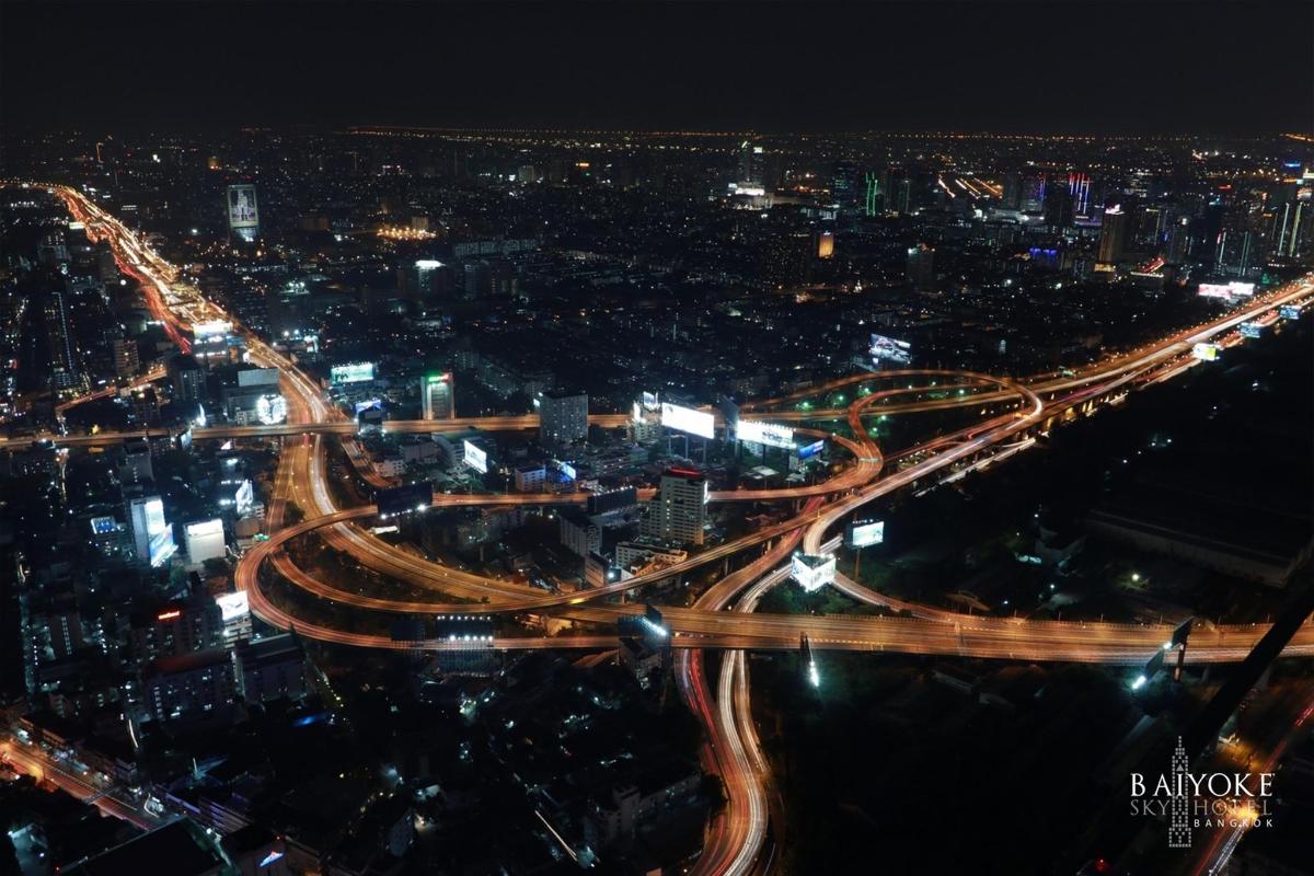 a city lit up at night with traffic