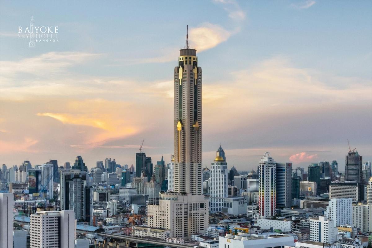 a city skyline with a tall skyscraper