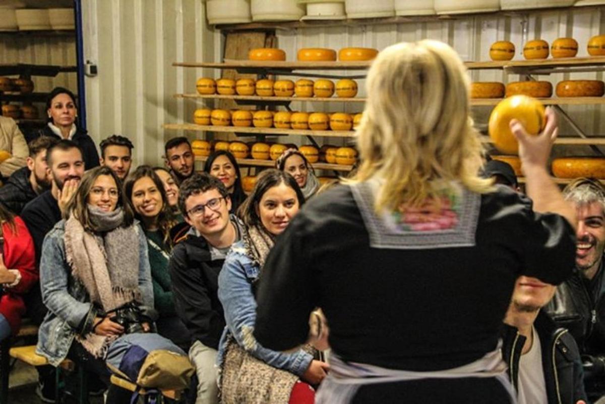 a group of people standing in a room with a woman
