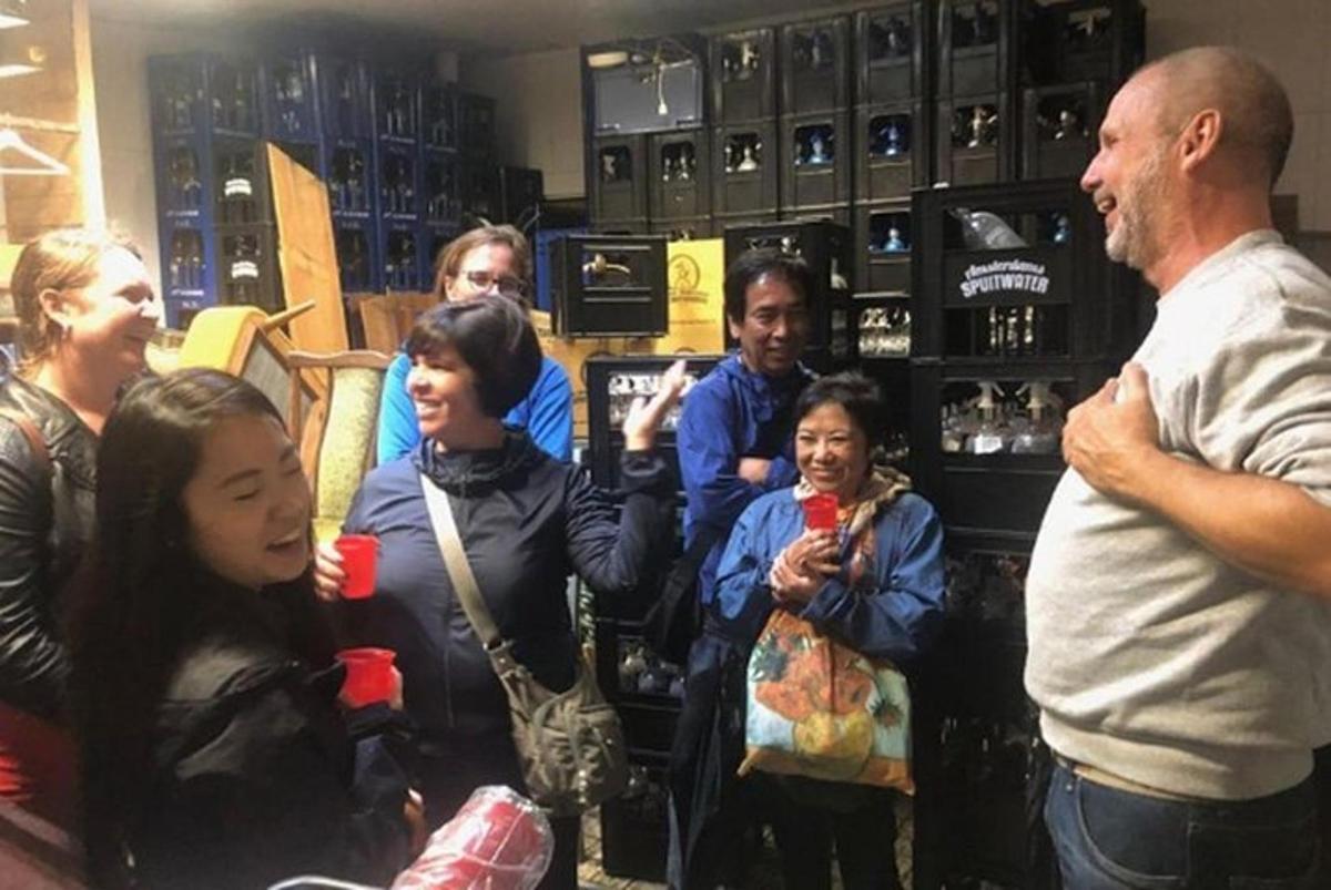 a group of people standing in a store with a man