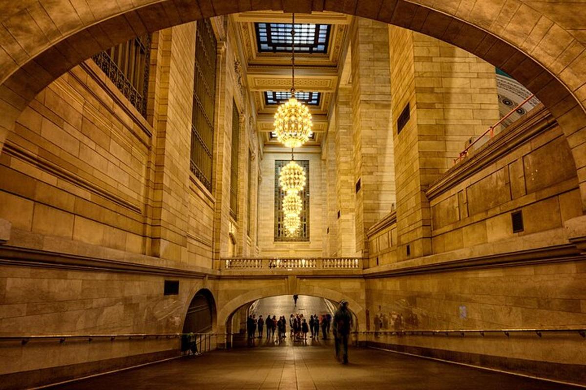 a man walking through a hallway in a large building