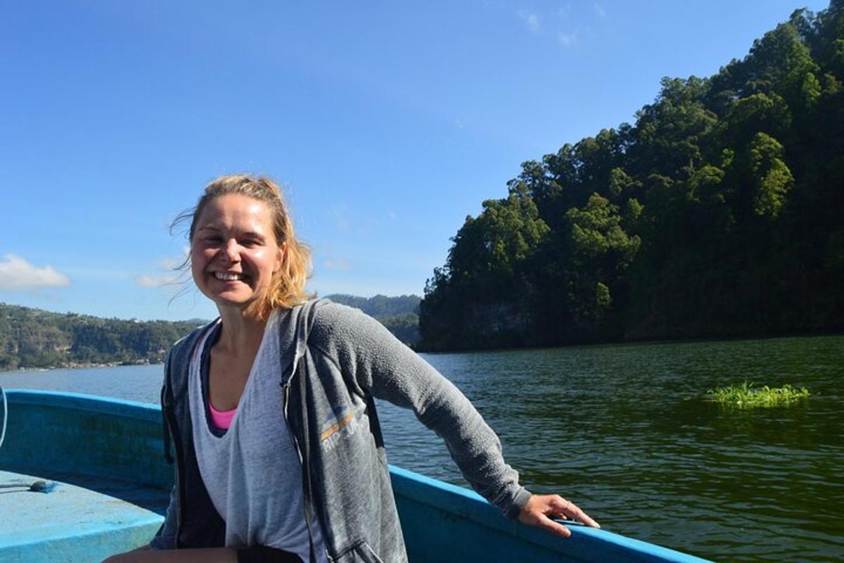 a woman sitting in a boat on the water