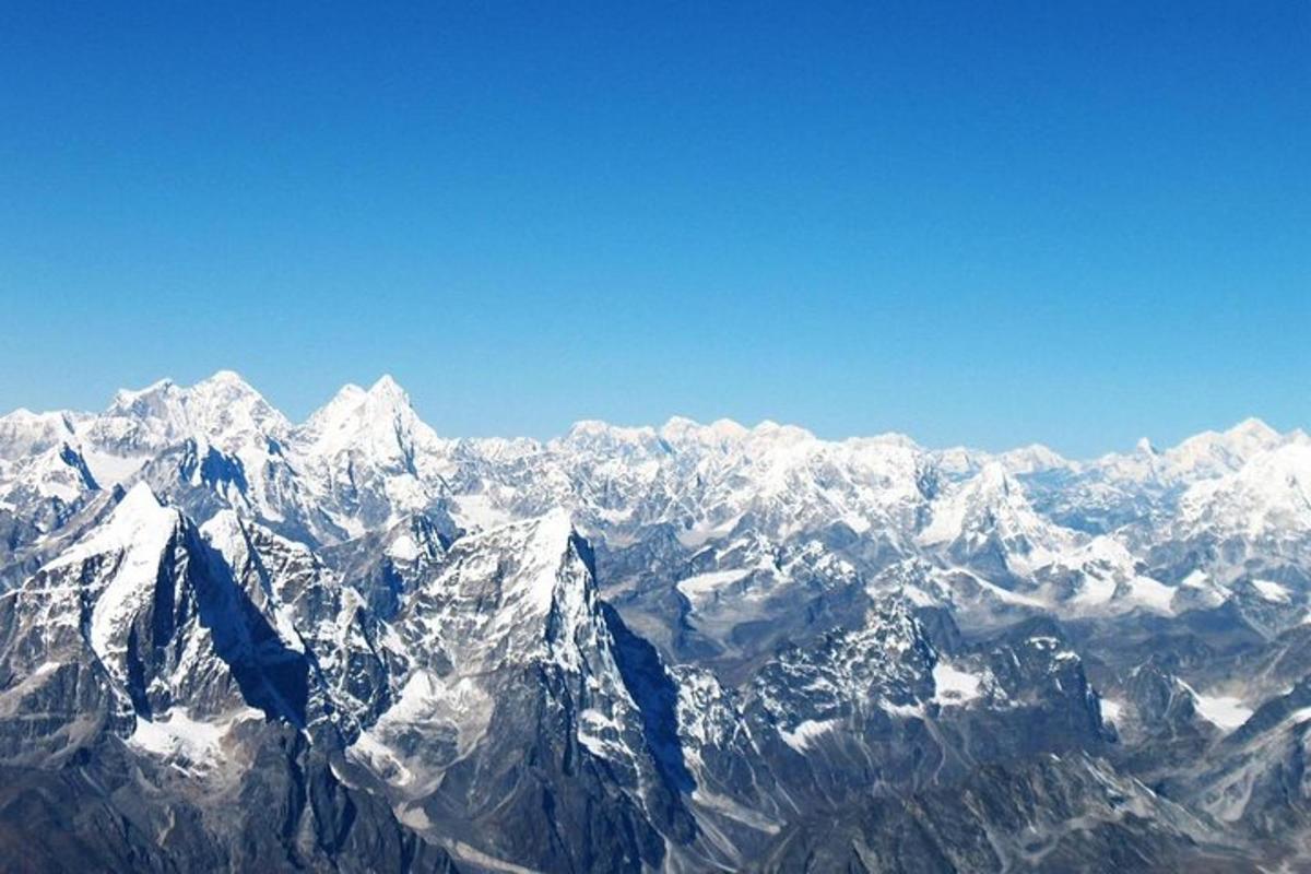an aerial view of a snow covered mountain range