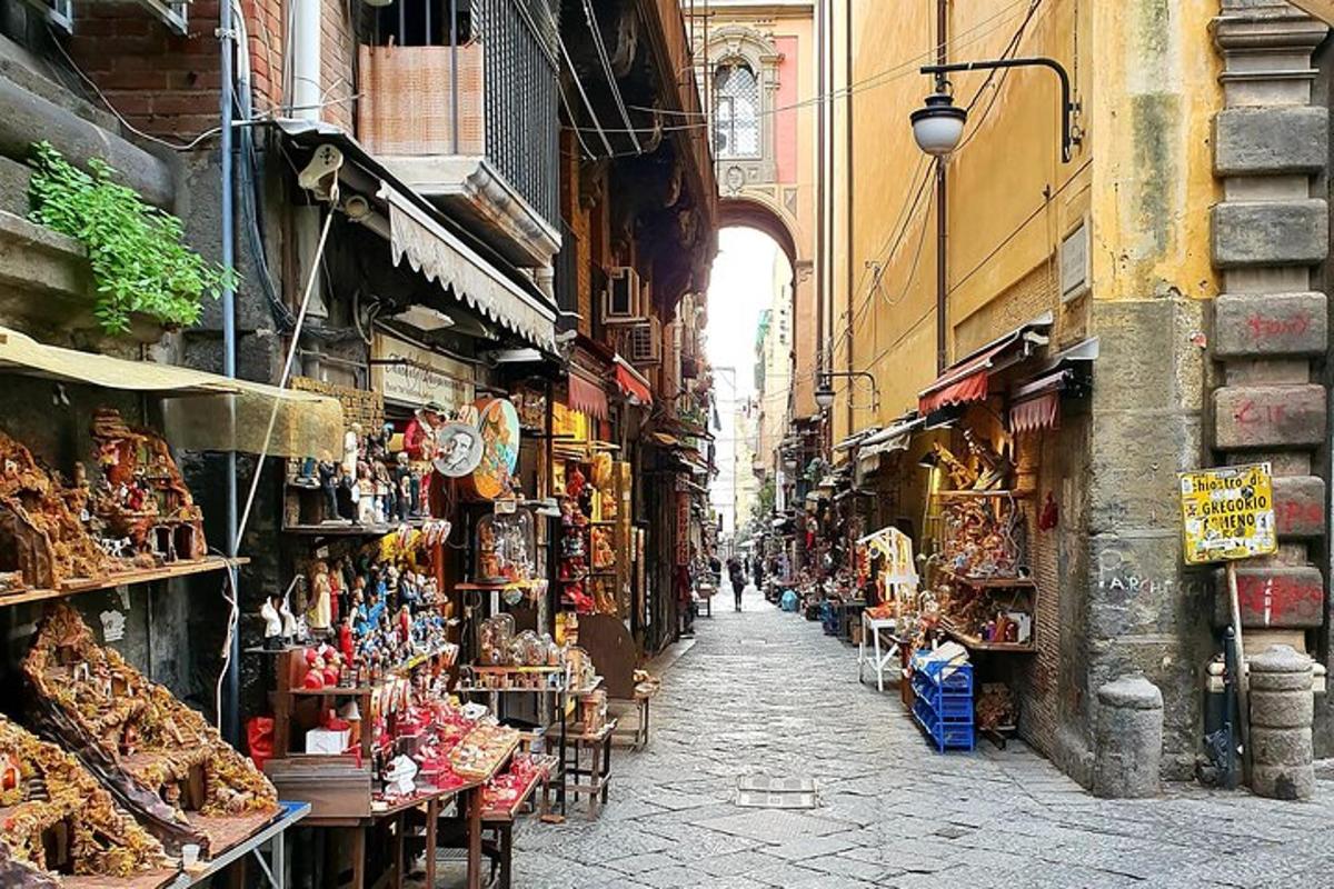 an alley with a bunch of shops in a city