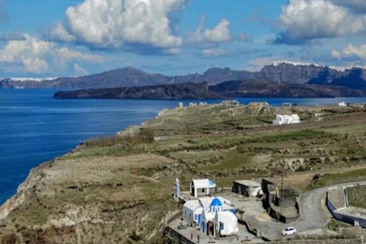 a group of tents on a hill next to the water