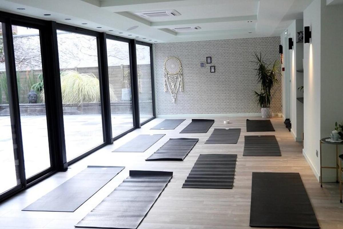 a room with a bunch of yoga mats on the floor